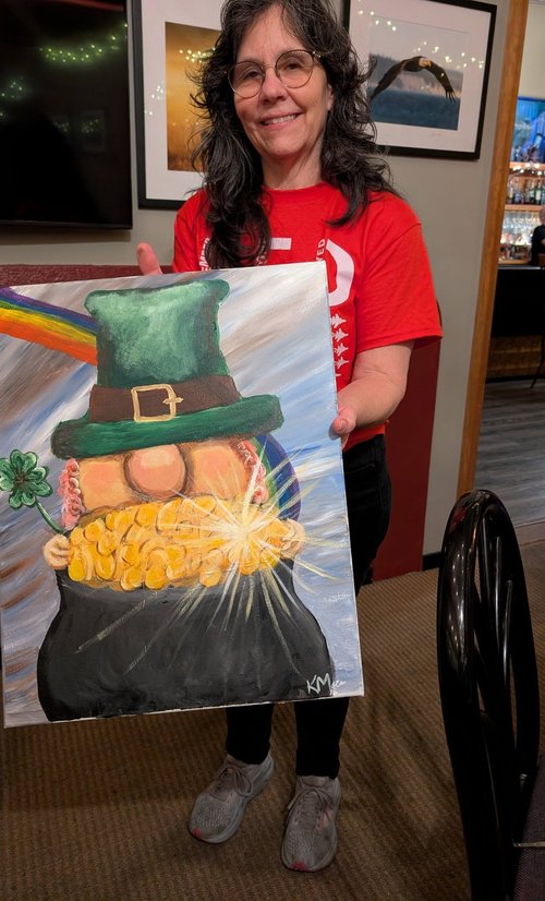 Guest holding a St. Patrick's Day painting