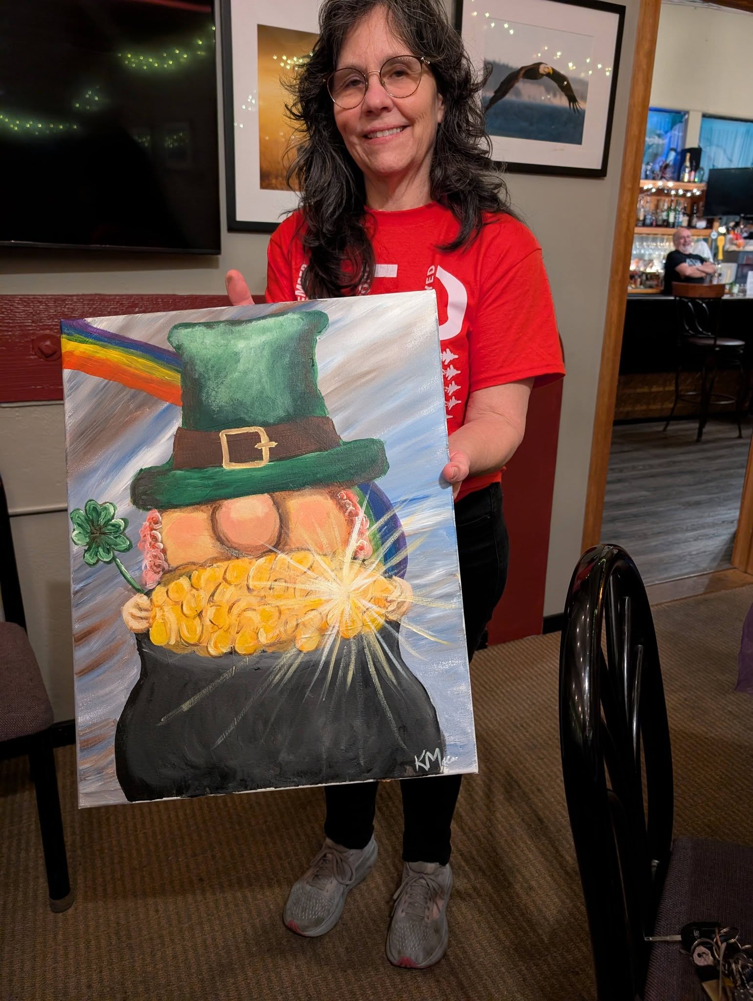 Guest holding a St. Patrick's Day painting