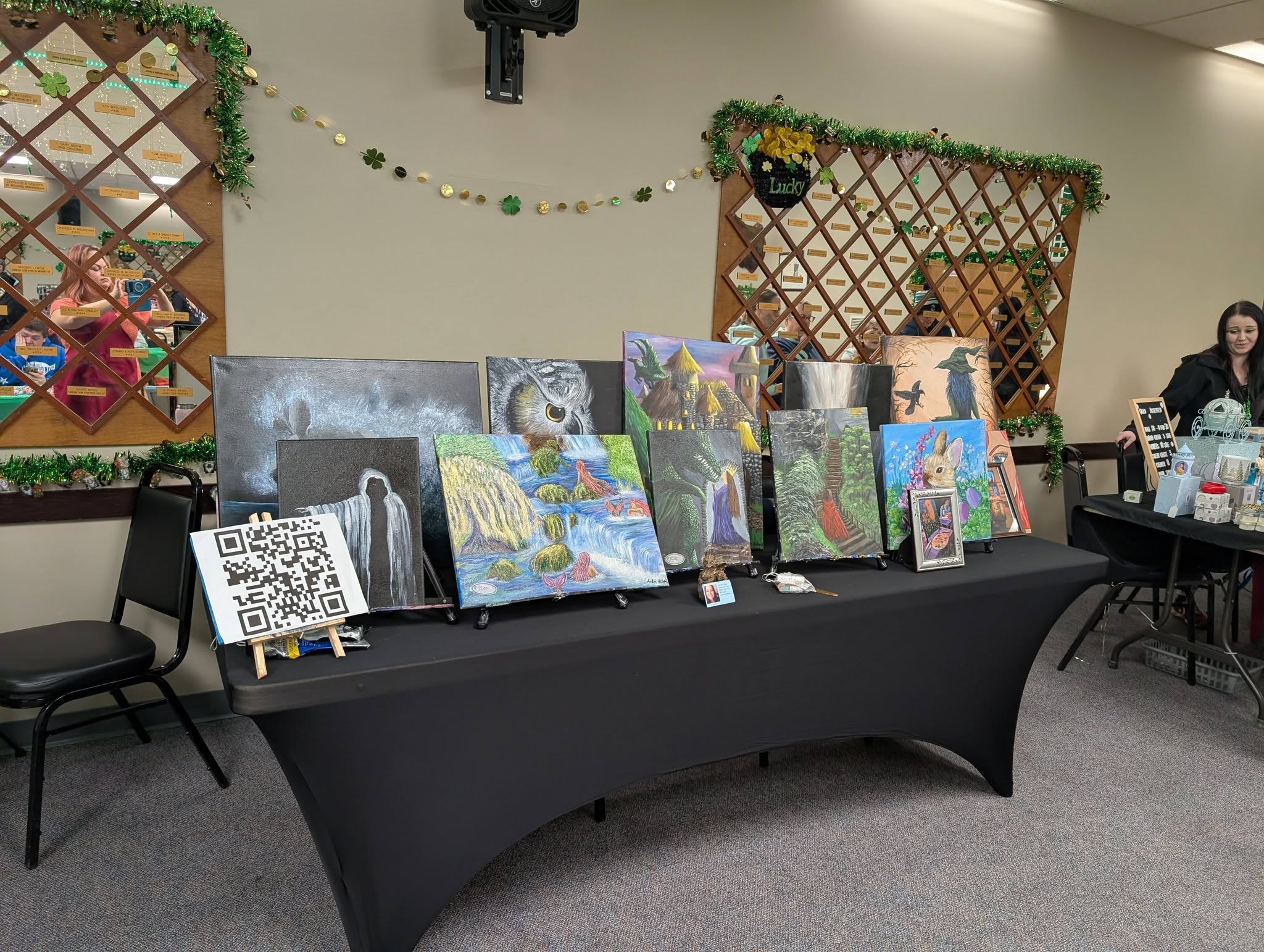 Table of original paintings displayed at a local event