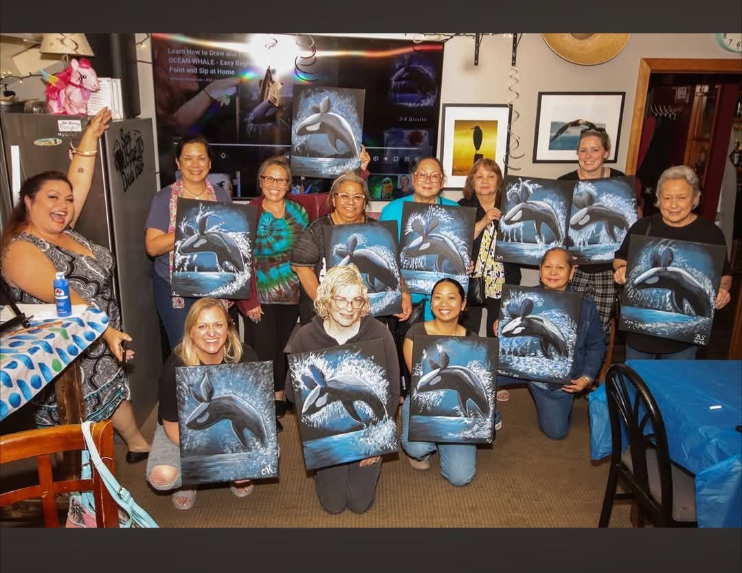 Large paint night group holding their finished paintings