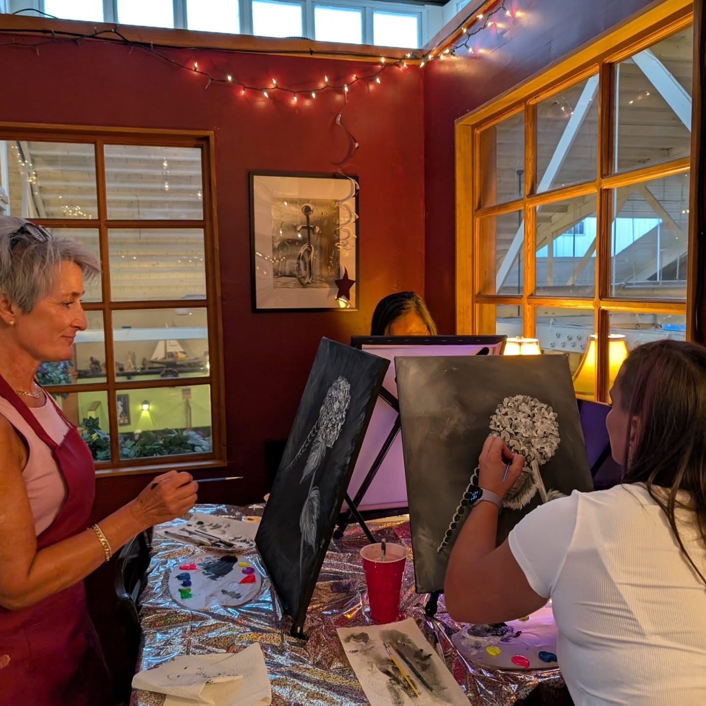 Painter working at an easel during a class