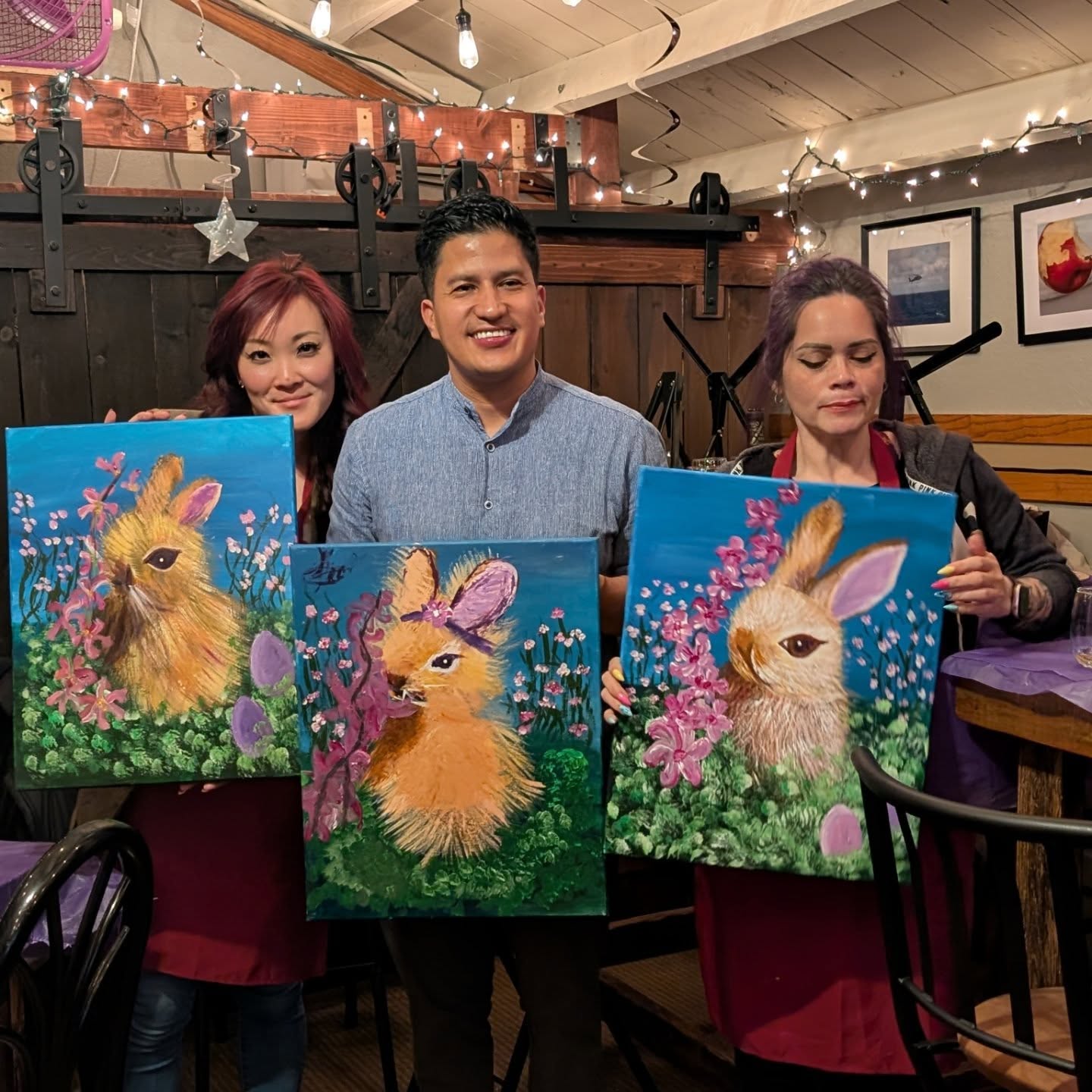 Group holding colorful bunny paintings