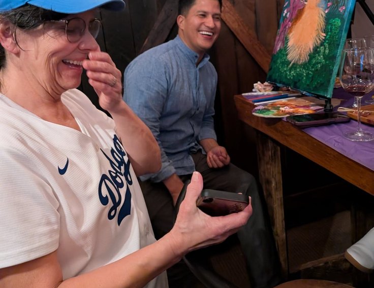 Guest laughing during a paint class