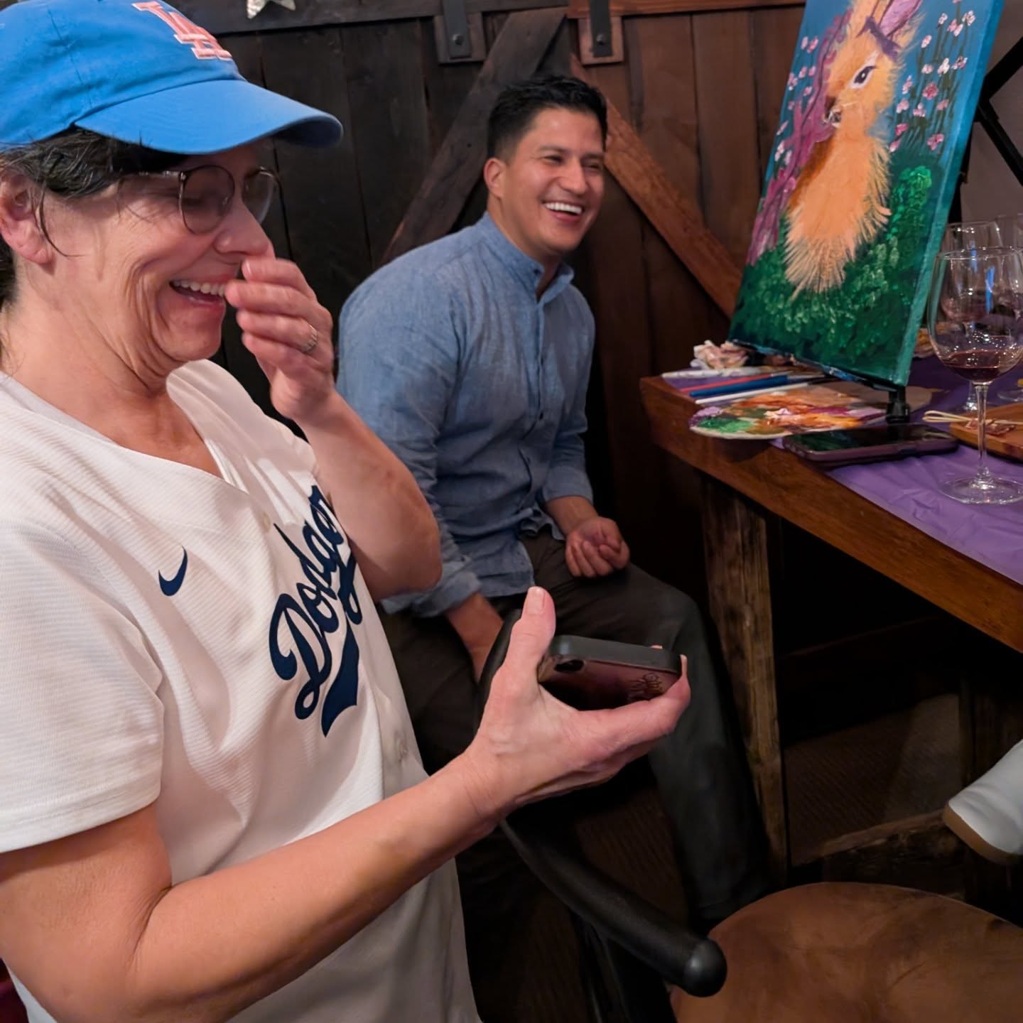 Guest laughing during a paint class