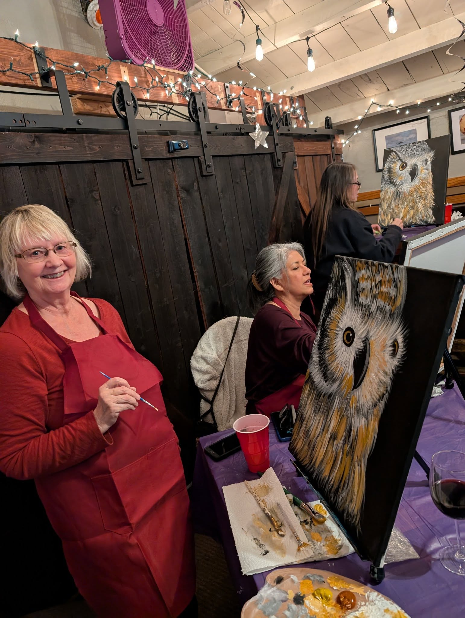 Guest standing proudly with her owl painting