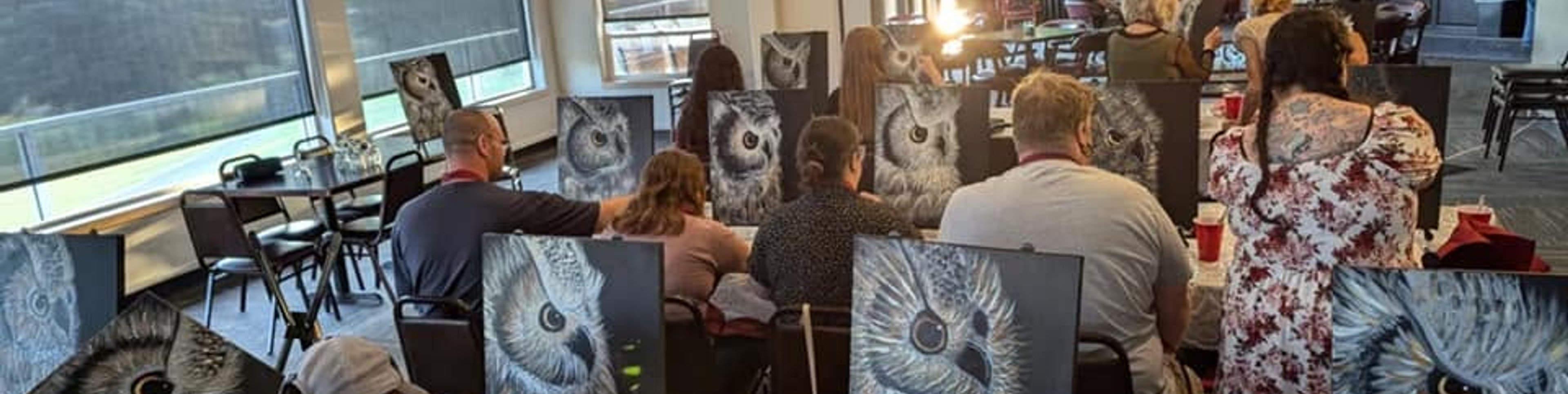 Paint class in a bright room overlooking the water