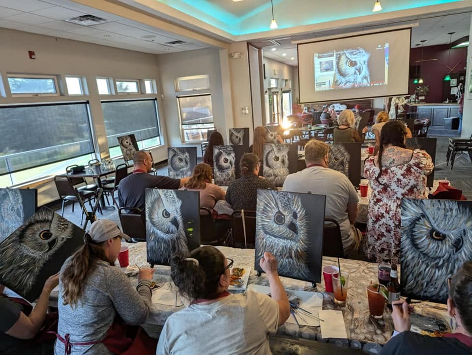 Paint class in a bright room overlooking the water