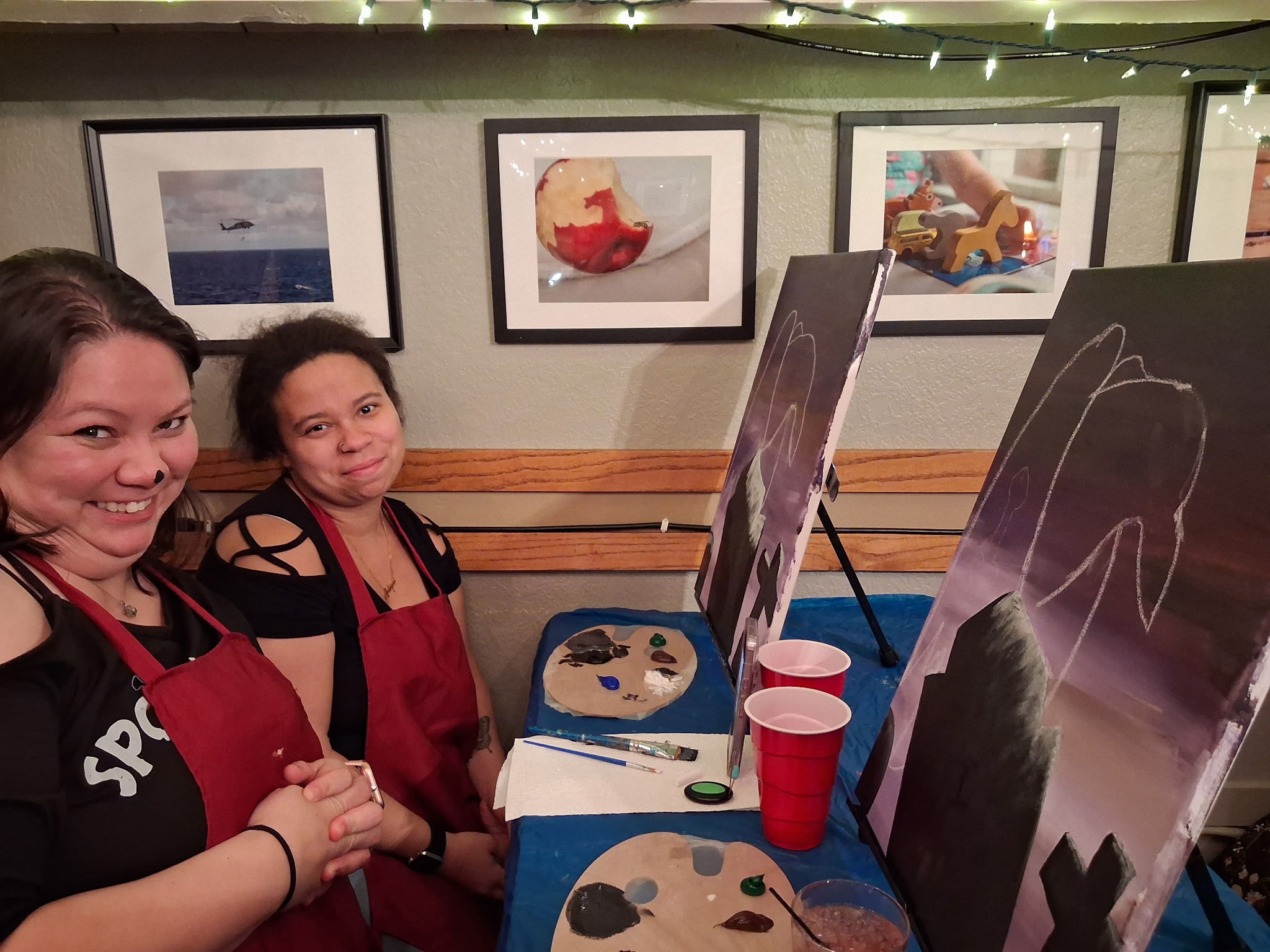 Guest painting a wine glass at a paint and sip class