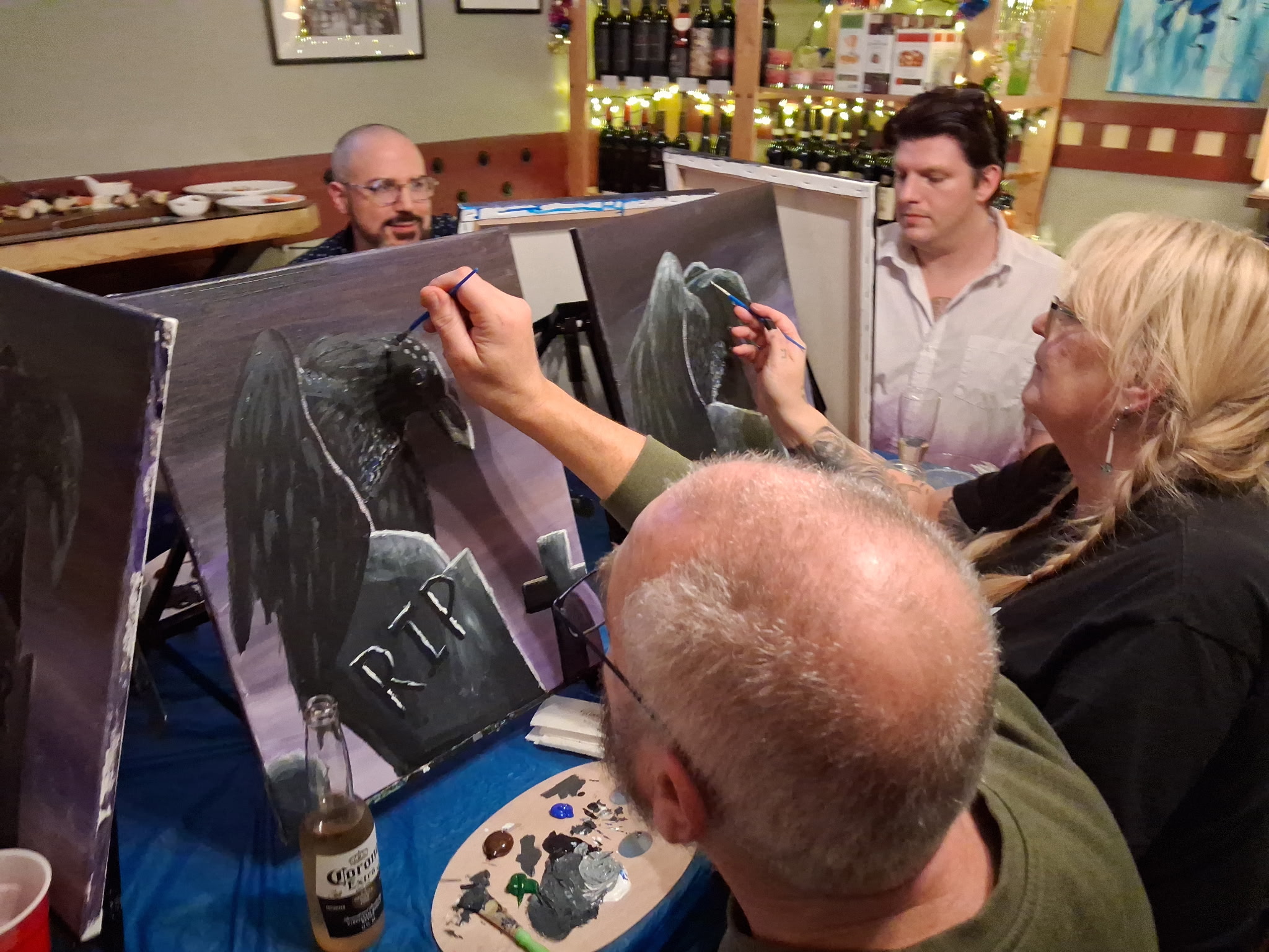 Paint class group showing off spring bunny paintings